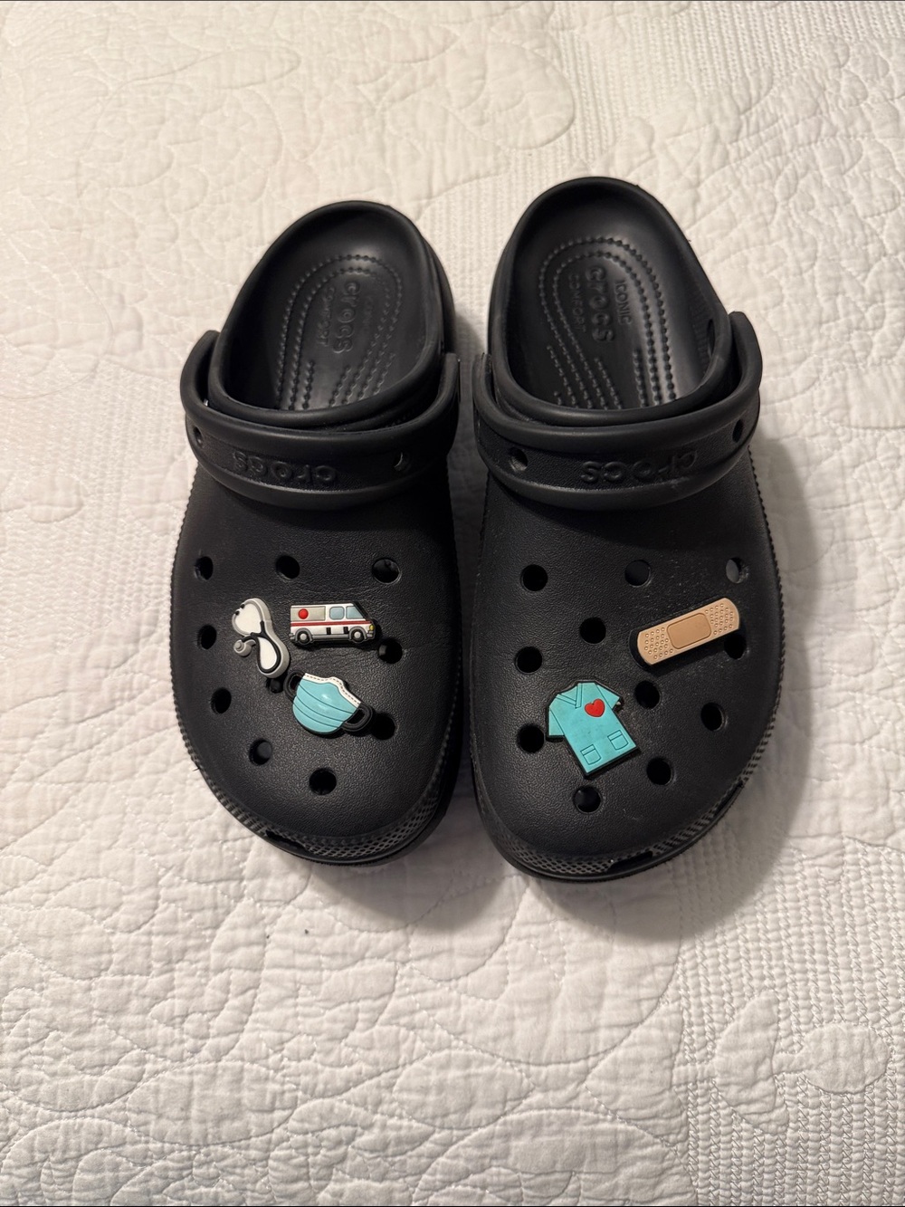 Women’s platform crocs with Medical Charm Jibbitz. Size 9 in black.